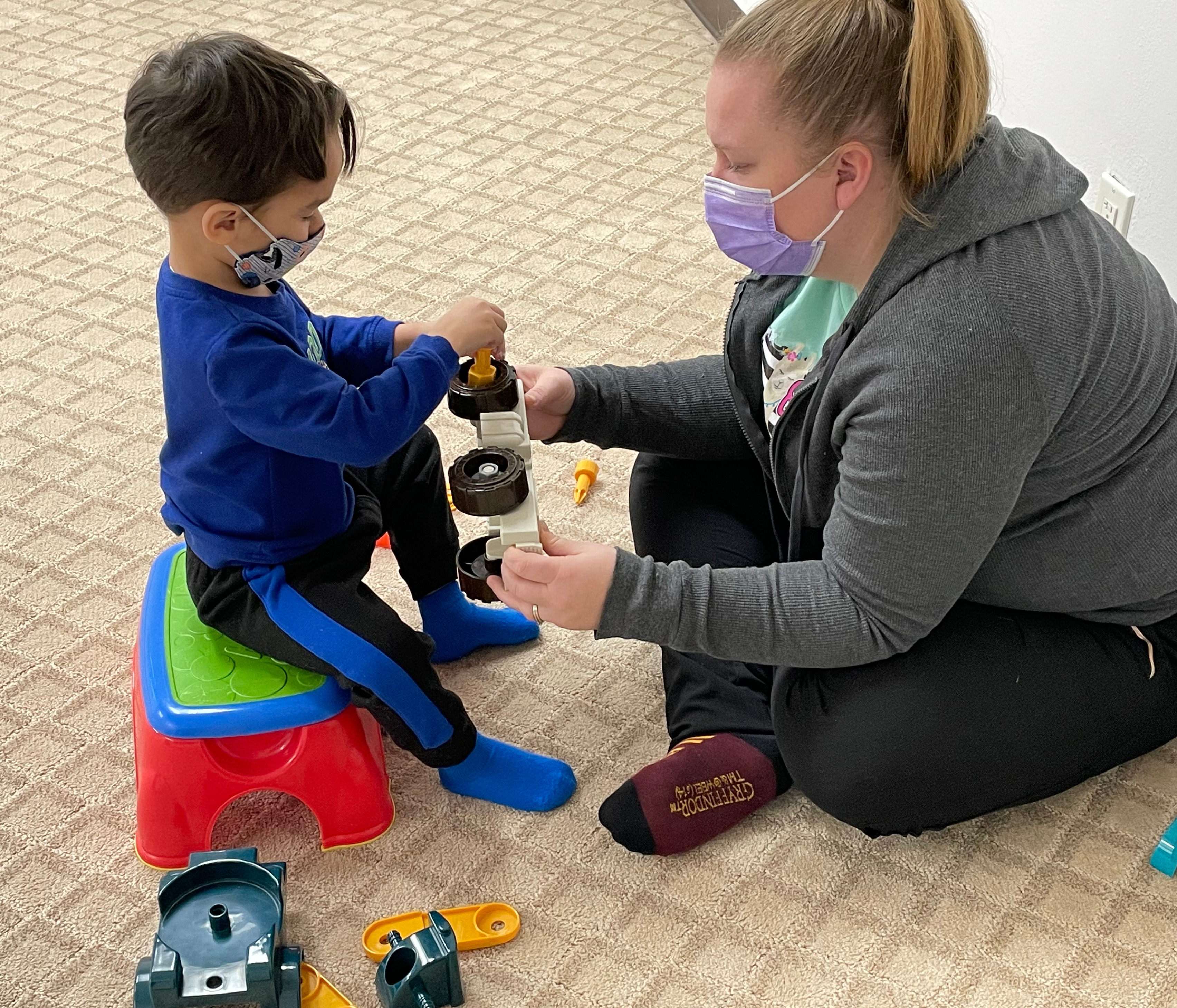 Image of a Child building a truck with the therapist