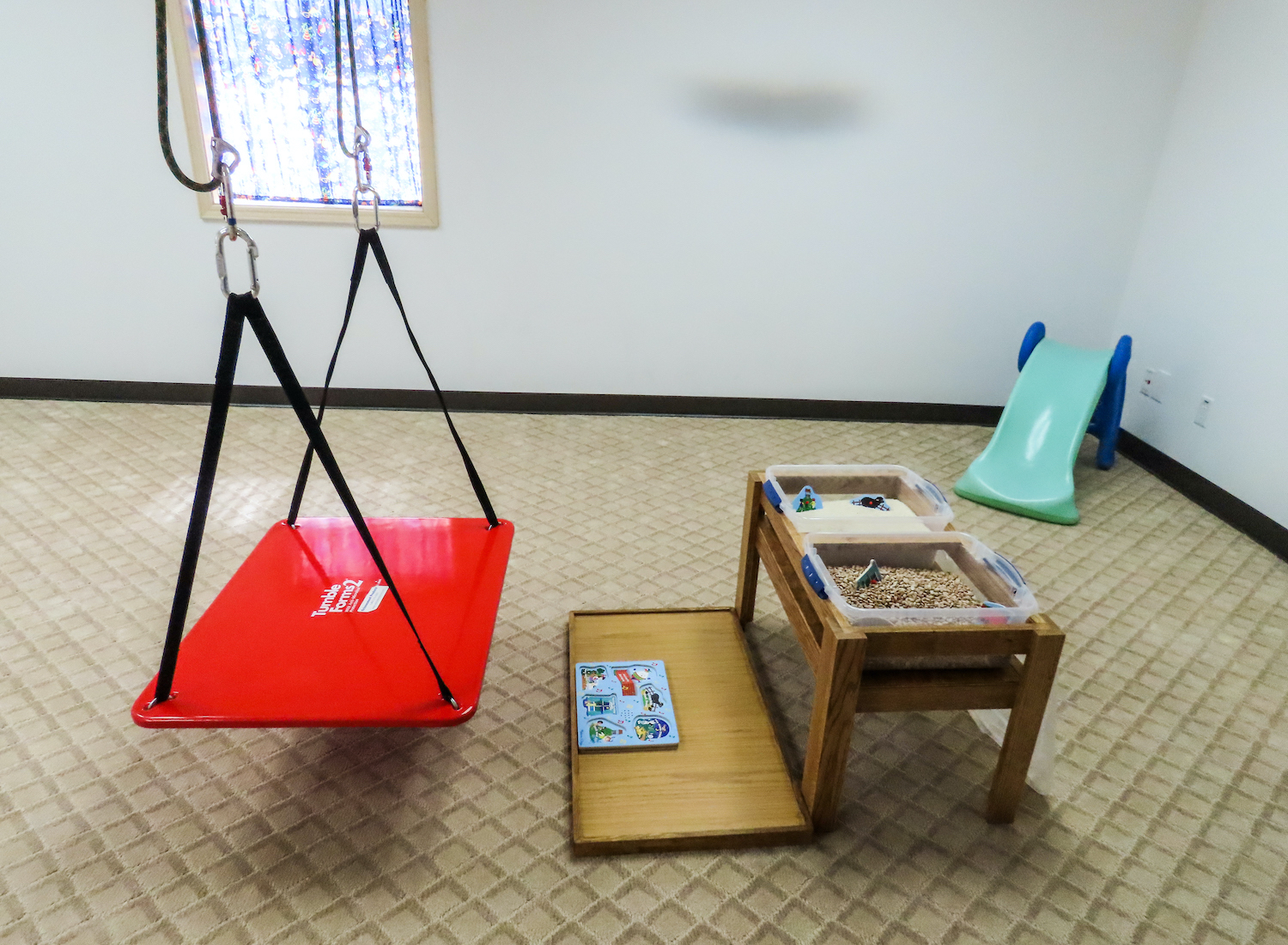 movement room photo of swing and sensory table